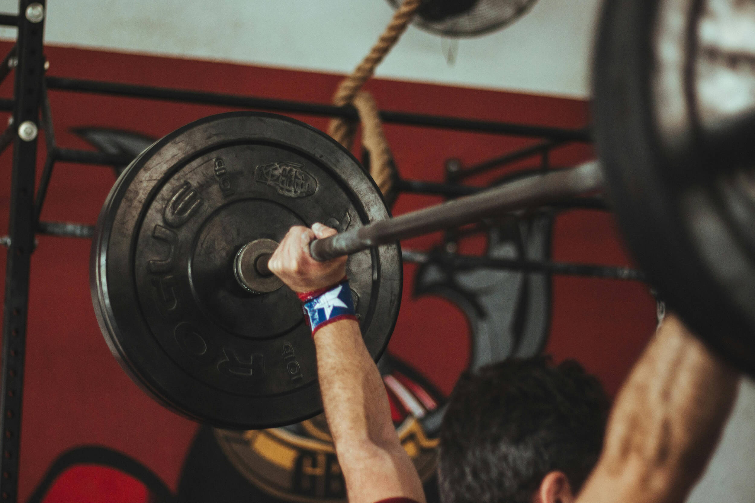 Man lifting weight above head