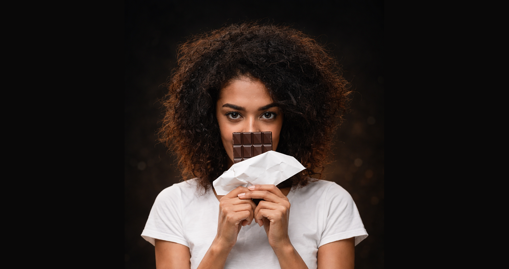 Chocolate For Fertility: woman is holding a chocolate bar
